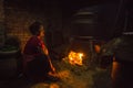 Nepalese woman working in the his pottery workshop.