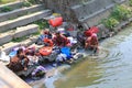 Nepalese women washing clothes along the river Royalty Free Stock Photo