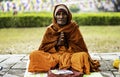 A Nepali Buddhist monk sits and prays in the cold weather at the Buddha\'s gate in Lumbini Park, Nepal