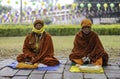 A Nepali Buddhist monk sits and prays in the cold weather at the Buddha\'s gate in Lumbini Park, Nepal