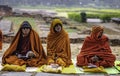 A Nepali Buddhist monk sits and prays in the cold weather at the Buddha\'s gate in Lumbini Park