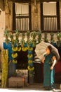 Nepali lady with umbrella outside a fruit shop, Kathmandu, Nepal