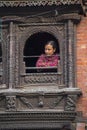 A Nepali girl sees outside from window , Kathmandu , Nepal Royalty Free Stock Photo