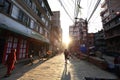 Nepali people walking down the Thamel street under sunrise in the morning in Kathmandu
