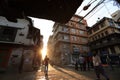 Nepali people walking down the Thamel street under sunrise in the morning in Kathmandu