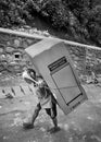 Nepali porter carrying refrigerator