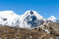 Nepali porter on his way from Chhukung to Island Peak with Lhotse wall in the background  Chhukung  Nepal Royalty Free Stock Photo