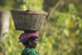 Nepali taru woman carrying basket in her head