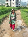 Nepali woman carrying a basket on her head in rural kathmandu nepal Royalty Free Stock Photo