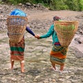 Nepali women crossing a river together