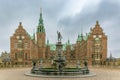 Neptune Fountain in front of Frederiksborg Castle on a cloudy day. Hillerod, Denmark. Royalty Free Stock Photo