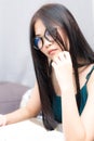 Nerd asian girl sitting on bed while reading book in a living room Royalty Free Stock Photo