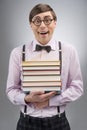 Nerd with book stack. Young nerd man holding a book stack while Royalty Free Stock Photo
