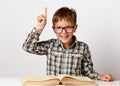 Closeup portrait child with glasses reading book, white background Royalty Free Stock Photo