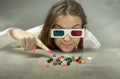 Nerd girl with 3d glasses indicated candy