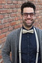 Nerd Guy With Glasses, Bow Tie, and Brick Wall Background Royalty Free Stock Photo