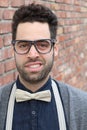 Nerd Guy With Glasses, Bow Tie, and Brick Wall Background Royalty Free Stock Photo
