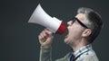 Nerd guy shouting a message using a megaphone