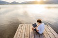 Nerd guy spending time outdoor programming at sunset writing code using laptop. New job opportunity at modern times to work Royalty Free Stock Photo