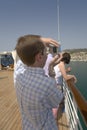 Nerd male shooting digital camera off cruise ship