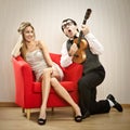 Nerd man boyfriend play ukulele love song for his girlfriend for valentine day Royalty Free Stock Photo