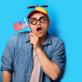 Nerd man with noob hat holding an American flag