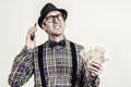 Nerd with money cash. Guy using smartphone. Male nerd with banknotes Royalty Free Stock Photo