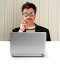 Nerd pensive man glasses silly expression laptop Royalty Free Stock Photo