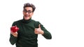 Nerd young man with piggybank isolated on white Royalty Free Stock Photo