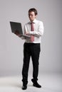 Nerdy businessman holding a laptop