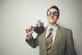 Nerdy businessman with old fashioned cine camera Royalty Free Stock Photo