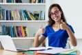 Nerdy female student learning language online using computer Royalty Free Stock Photo