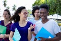 Nerdy female student talking with africane american male student Royalty Free Stock Photo