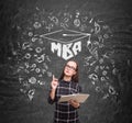 Nerdy girl and an mba sketch on blackboard Royalty Free Stock Photo