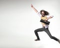 Nerdy guy holding a briefcase and jumping over the white board in the background Royalty Free Stock Photo
