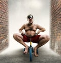 Nerdy man riding a small bicycle Royalty Free Stock Photo