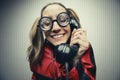 Nerdy woman speaking on a black rotary vintage phone