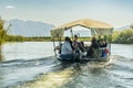 NERETVA, CROATIA, SEPTEMBER 30, 2017: boat safari with tourist on the neretva river delta , between tangerine tree and orange tree