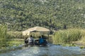 NERETVA, CROATIA, SEPTEMBER 30, 2017: boat safari with tourist on the neretva river delta , between tangerine tree and orange tree