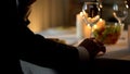 Nervous aged man in suit waiting date at restaurant table, romantic tradition Royalty Free Stock Photo