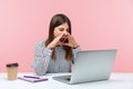 Nervous angry business woman in striped shirt loudly screaming holding hands near mouth, talking video conference sitting at