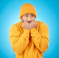 Nervous, anxiety and asian man biting nails in studio with terror, fear and scared for secret phobia on blue background