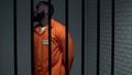 Nervous black prisoner waiting sentence in solitary cell, convicted criminal Royalty Free Stock Photo