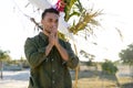 Nervous caucasian groom with hands on face standing against decoration at wedding ceremony