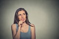 Nervous looking young woman biting her fingernails Royalty Free Stock Photo