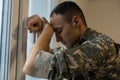 Nervous male military suffering depression, sitting alone at home, PTSD concept Royalty Free Stock Photo