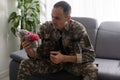 Nervous male military suffering depression, sitting alone at home, PTSD concept Royalty Free Stock Photo