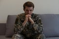 Nervous male military suffering depression, sitting alone at home, PTSD concept. Royalty Free Stock Photo