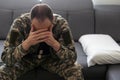 Nervous male military suffering depression, sitting alone at home, PTSD concept Royalty Free Stock Photo