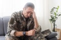 Nervous male military suffering depression, sitting alone at home, PTSD concept Royalty Free Stock Photo